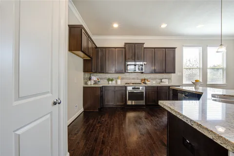 a kitchen with stainless steel appliances sink refrigerator and cabinets