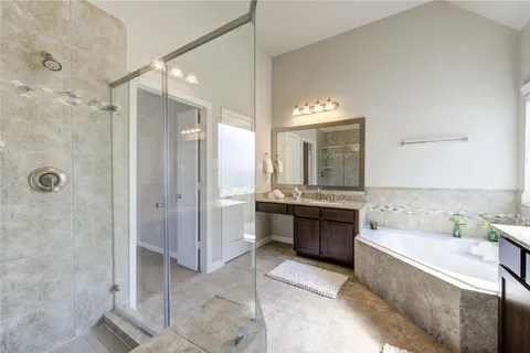 a bathroom with a tub sink and mirror