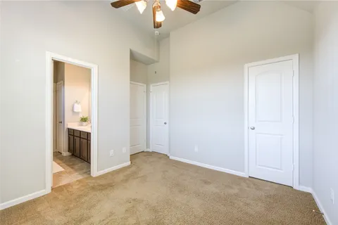 a view of a room with a chandelier fan and closet