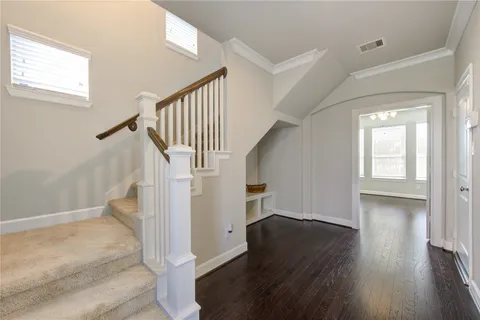 a view of entryway with wooden floor and stairs