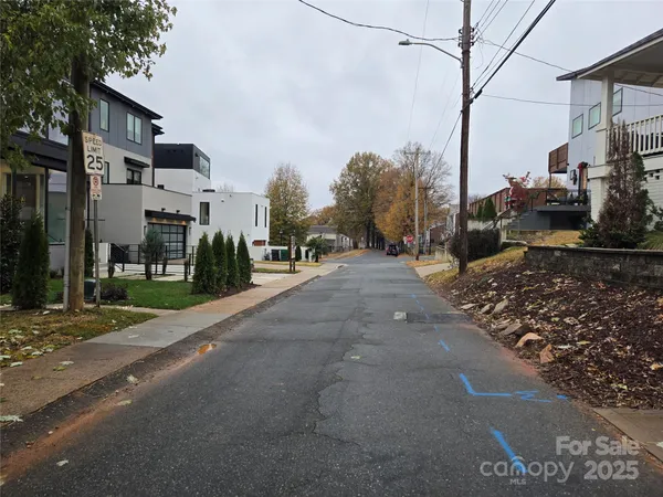a view of a street with houses on both side
