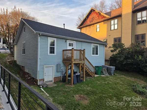 a view of a house with a yard and stairs