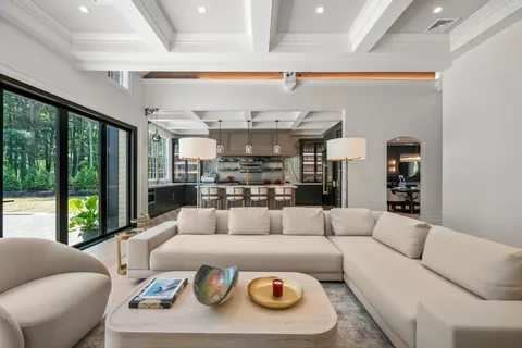 a kitchen with stainless steel appliances granite countertop a stove a sink and a granite counter tops with a large window