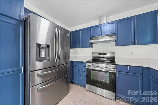 a kitchen with granite countertop stainless steel appliances and wooden cabinets