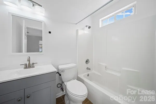 a bathroom with a sink toilet vanity and shower