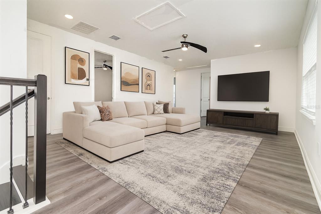 15701 Vetta Drive Montverde, FL 34756 - Photo 11 of 68 a living room with furniture and a flat screen tv