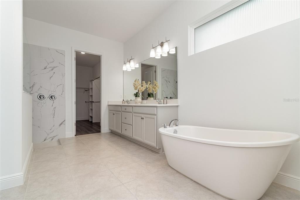 15701 Vetta Drive Montverde, FL 34756 - Photo 14 of 68 a white bath tub sitting next to a bathroom sink