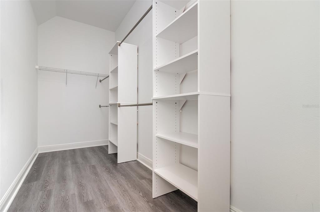 15701 Vetta Drive Montverde, FL 34756 - Photo 30 of 68 a view of walk in closet with empty racks