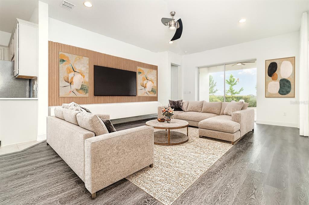 15701 Vetta Drive Montverde, FL 34756 - Photo 3 of 68 a living room with furniture and a flat screen tv