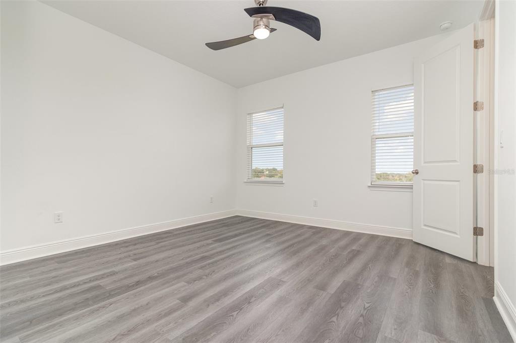 15701 Vetta Drive Montverde, FL 34756 - Photo 35 of 68 a view of an empty room with wooden floor and a window