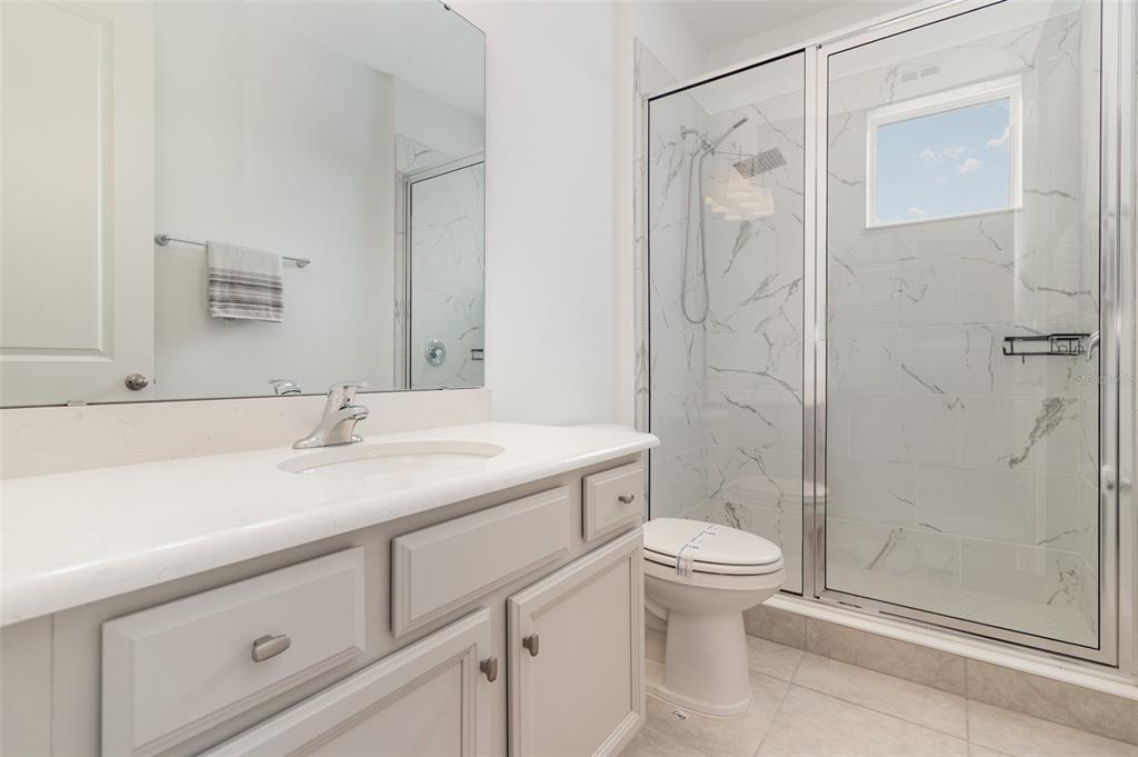 15701 Vetta Drive Montverde, FL 34756 - Photo 37 of 68 a bathroom with a sink a toilet and shower