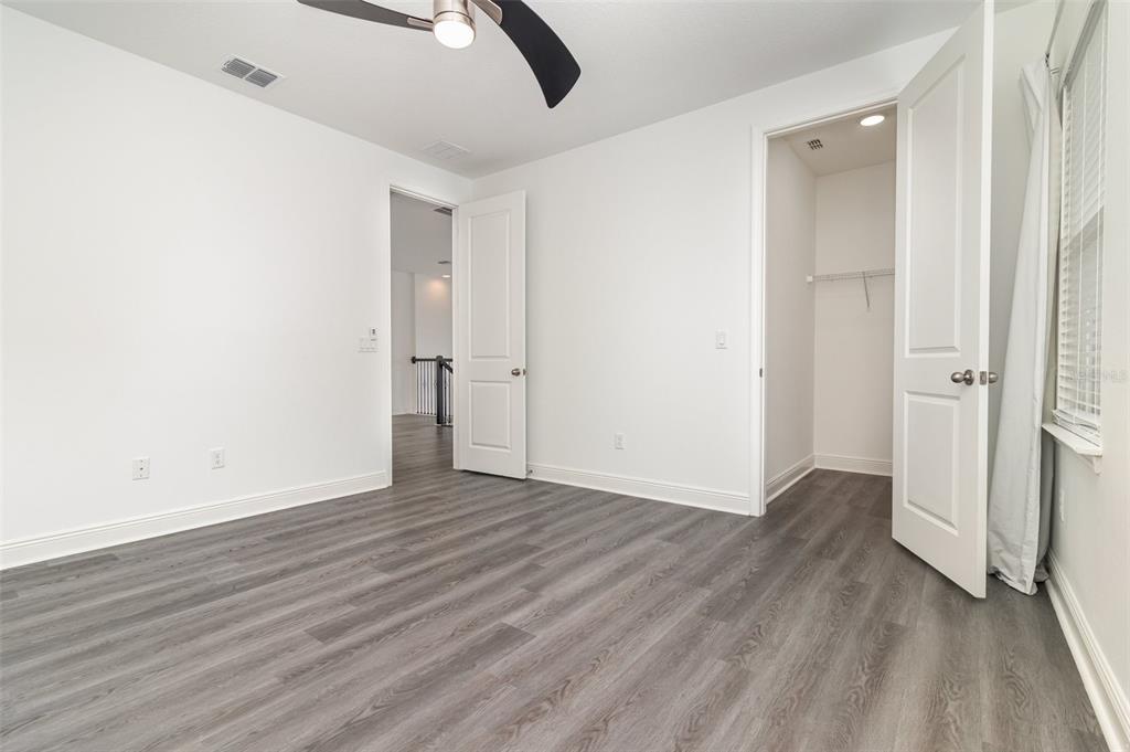 15701 Vetta Drive Montverde, FL 34756 - Photo 39 of 68 an empty room with wooden floor and entrance