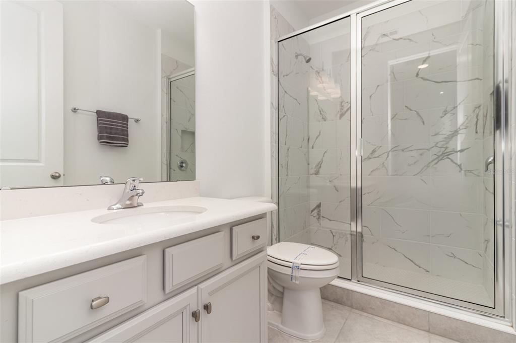 15701 Vetta Drive Montverde, FL 34756 - Photo 40 of 68 a bathroom with a sink a toilet and shower