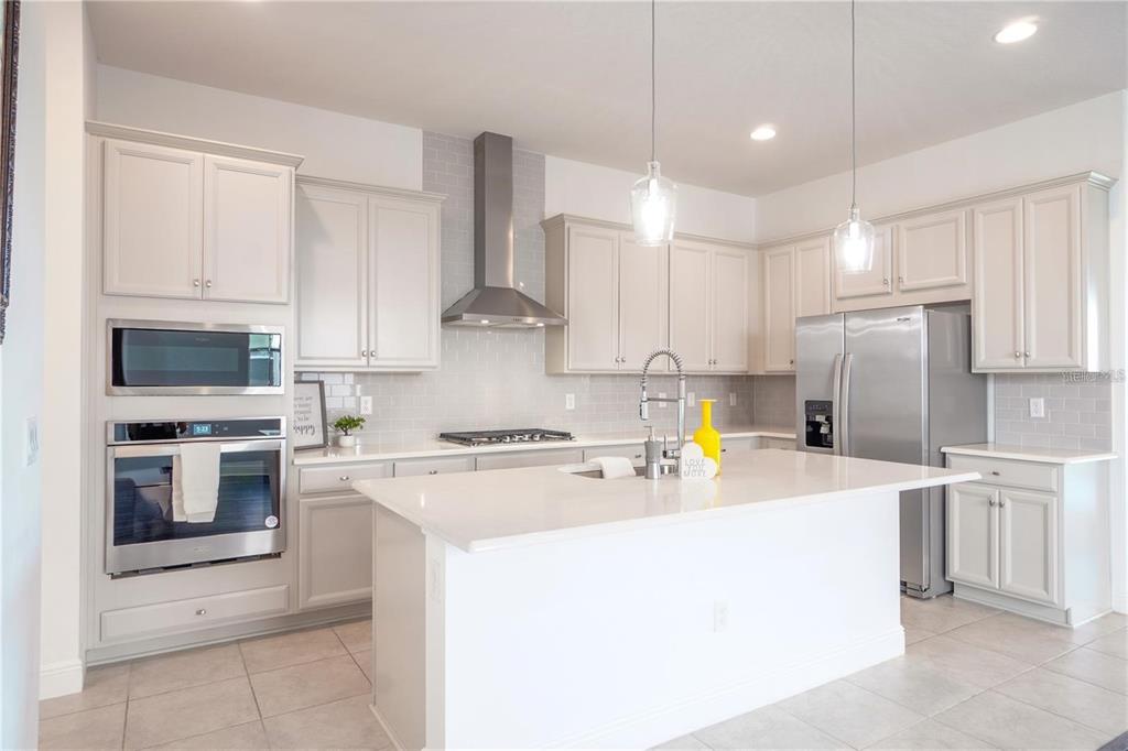 15701 Vetta Drive Montverde, FL 34756 - Photo 4 of 68 a kitchen with a sink a stove and refrigerator
