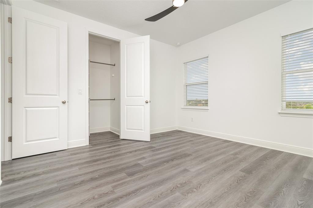 15701 Vetta Drive Montverde, FL 34756 - Photo 41 of 68 an empty room with wooden floor closet and windows