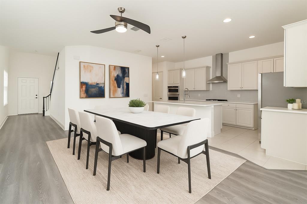 15701 Vetta Drive Montverde, FL 34756 - Photo 5 of 68 a view of a dining room with furniture and wooden floor