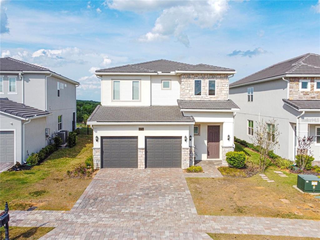 15701 Vetta Drive Montverde, FL 34756 - Photo 68 of 68 a front view of a house with a yard and garage