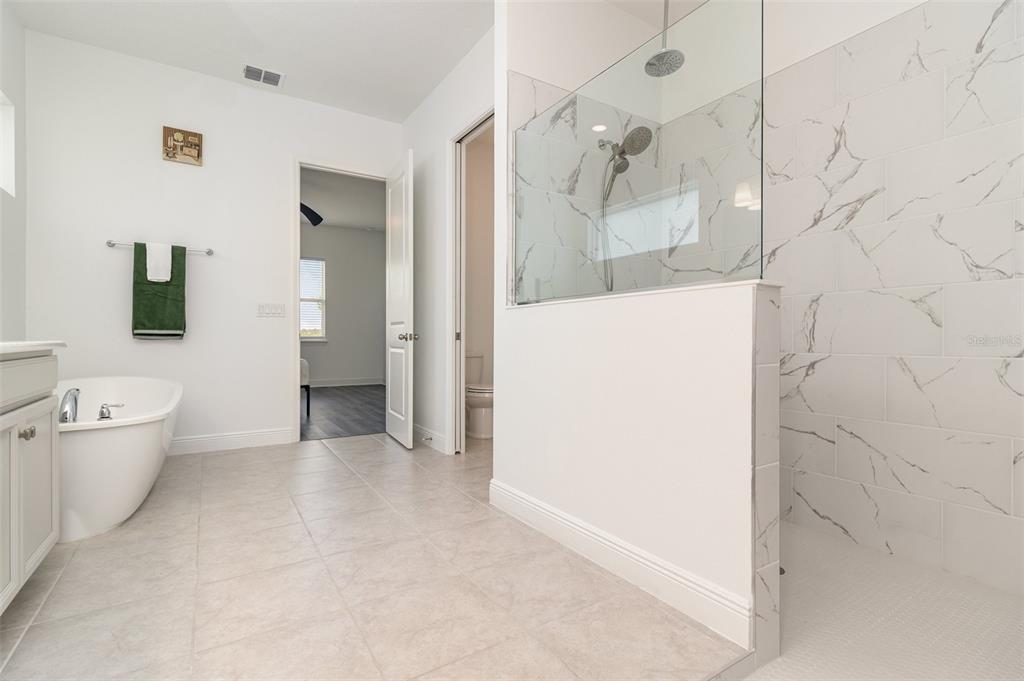 15701 Vetta Drive Montverde, FL 34756 - Photo 7 of 68 a view of a bathroom with a shower and a toilet