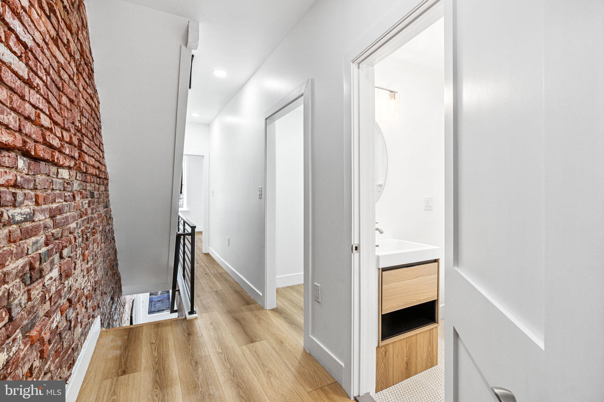 908 Reed Street Philadelphia, PA 19147 - Photo 16 of 33 a view of hallway with stairs and a wooden floor
