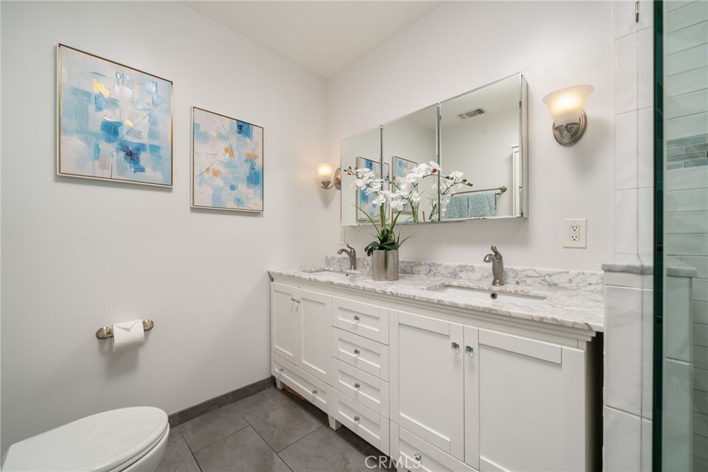 536 North Pennsylvania Avenue Glendora, CA 91741 - Photo 14 of 38 a bathroom with a toilet a sink and mirror