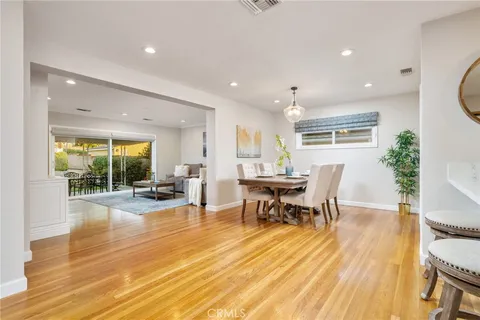 a view of a dining hall with furniture and wooden floor