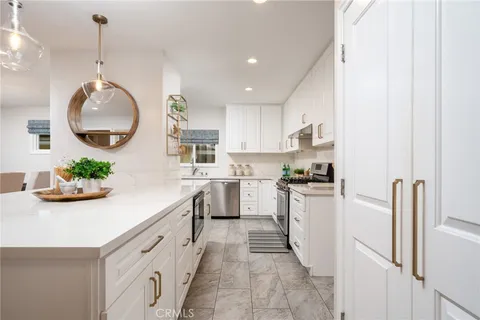 a kitchen with cabinets and window