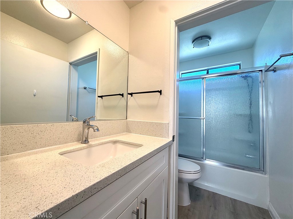 2114 Cedar Street, Unit E Alhambra, CA 91801 - Photo 12 of 13 a bathroom with a granite countertop sink toilet and shower