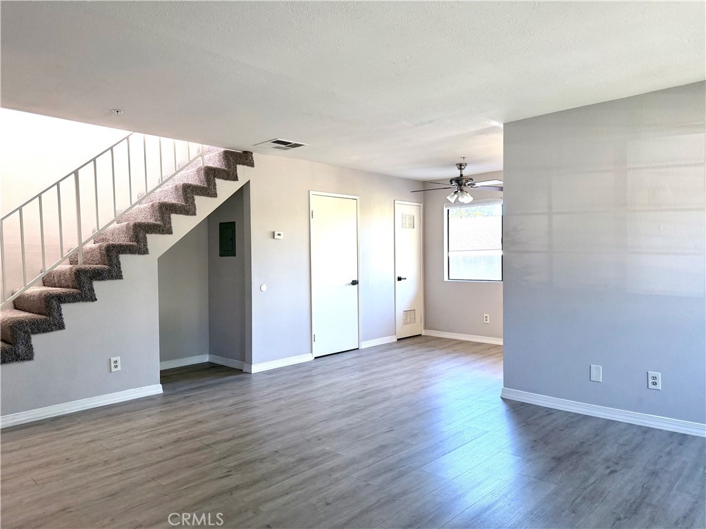 2114 Cedar Street, Unit E Alhambra, CA 91801 - Photo 5 of 13 a view of an empty room with wooden floor and stairs