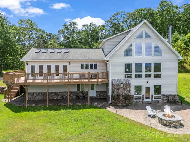 a aerial view of a house with a yard table and chairs