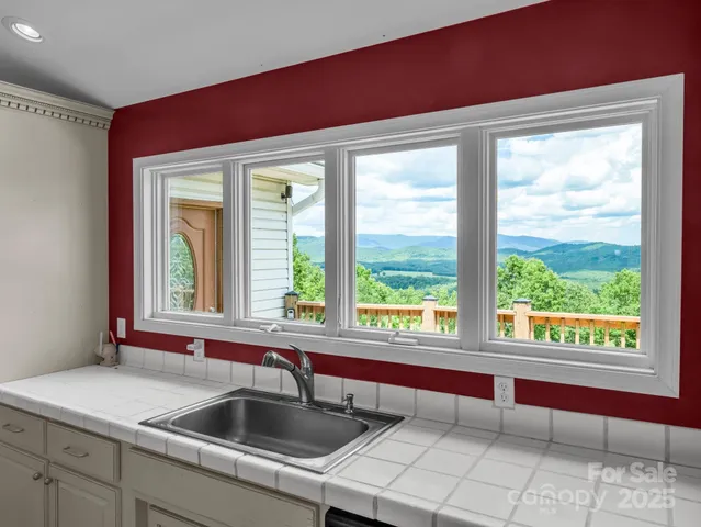 a kitchen with a sink and large window