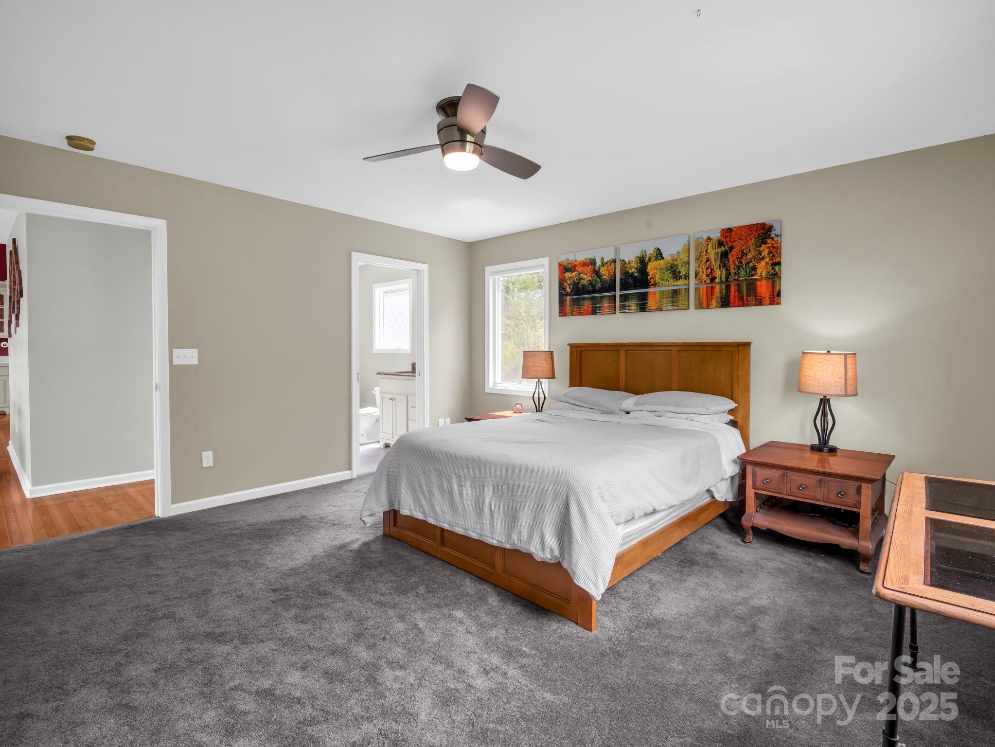 995 Towery Trace Road Ellenboro, NC 28040 - Photo 15 of 47 a bedroom with a bed and a chandelier