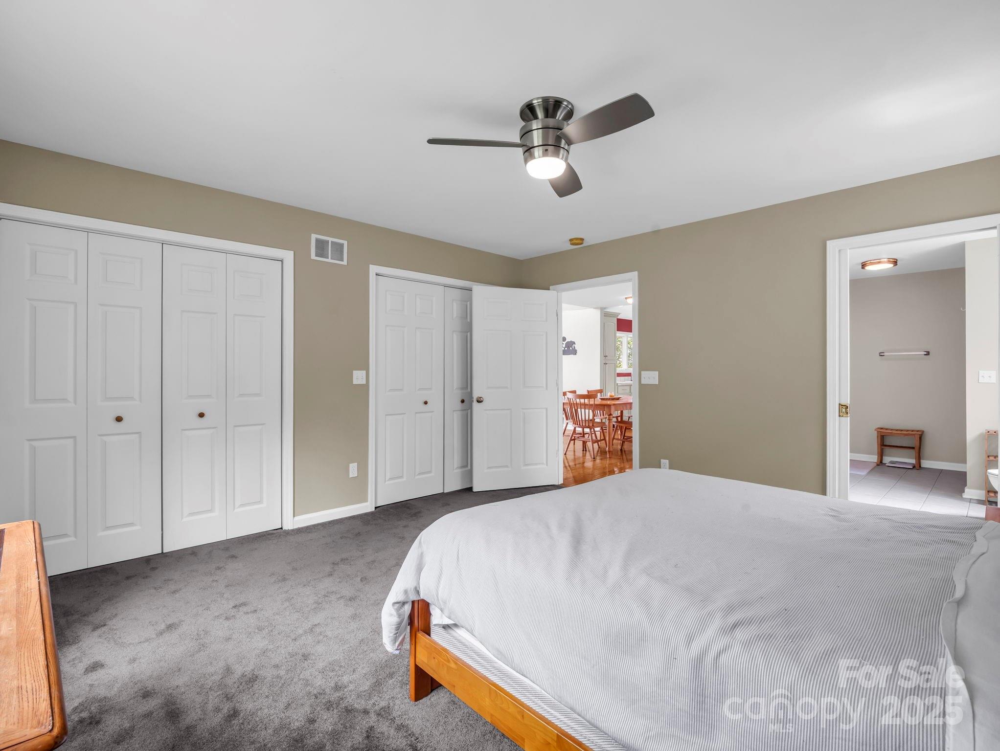 995 Towery Trace Road Ellenboro, NC 28040 - Photo 16 of 47 a bedroom with a large bed and a chandelier