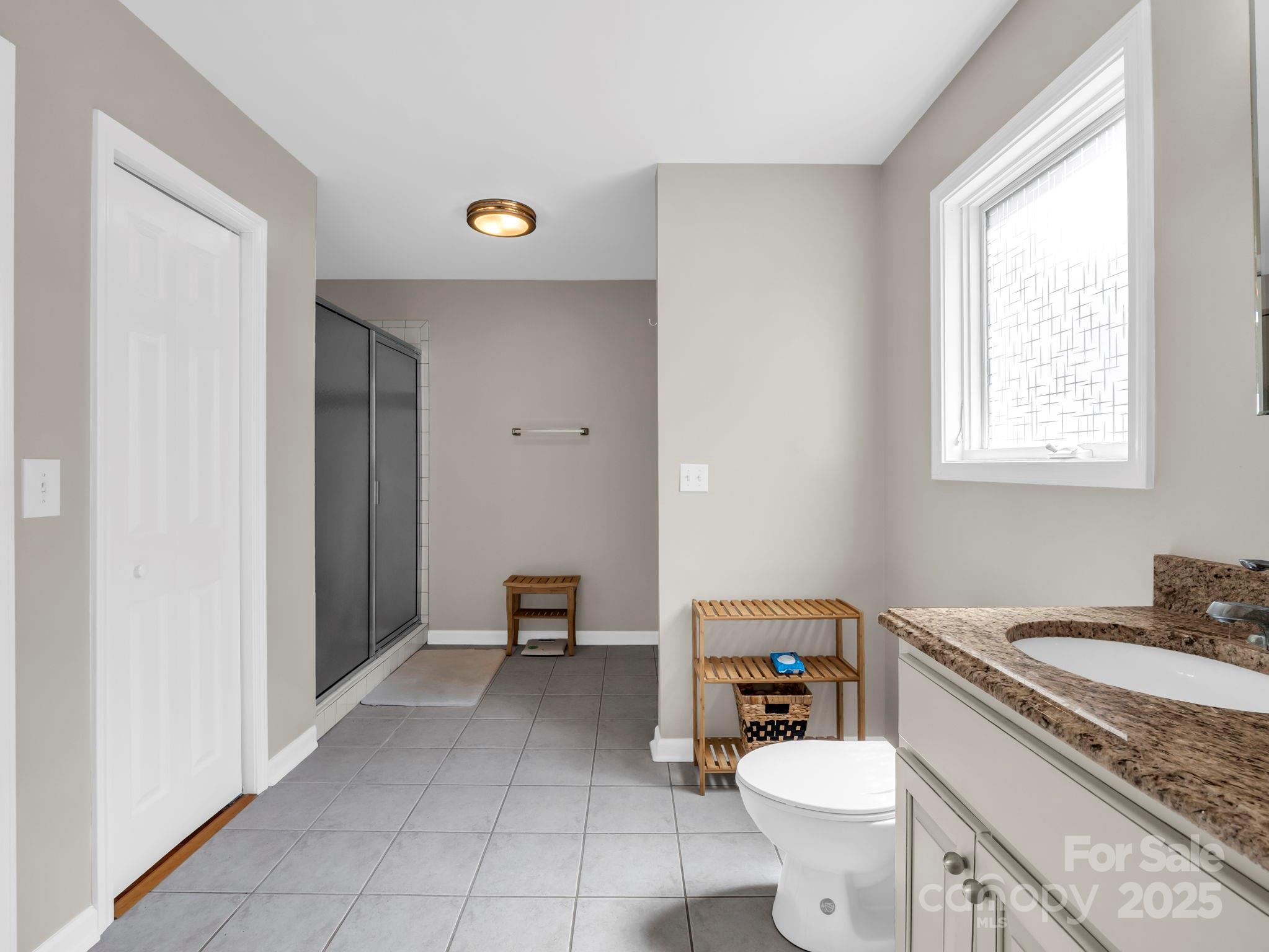 995 Towery Trace Road Ellenboro, NC 28040 - Photo 17 of 47 a bathroom with a granite countertop toilet sink and mirror