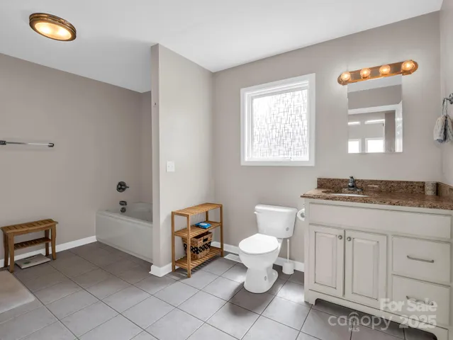 a bathroom with a sink a toilet and bathtub