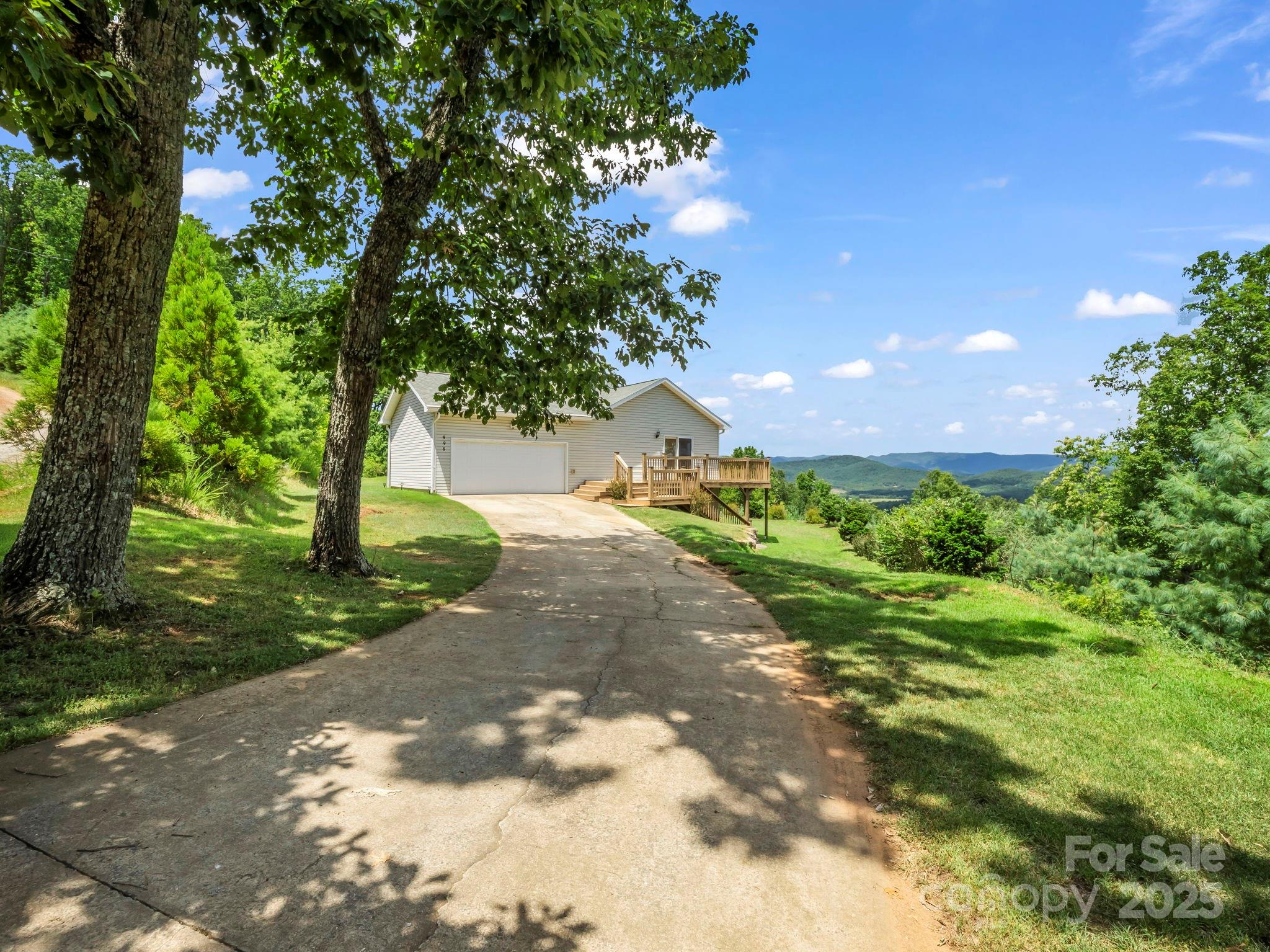 995 Towery Trace Road Ellenboro, NC 28040 - Photo 2 of 47 a view of a yard with plants and a large tree