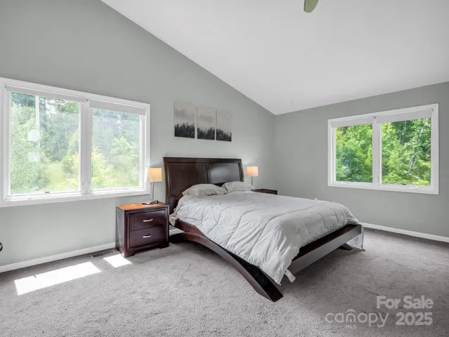 a bedroom with a bed lamp and window
