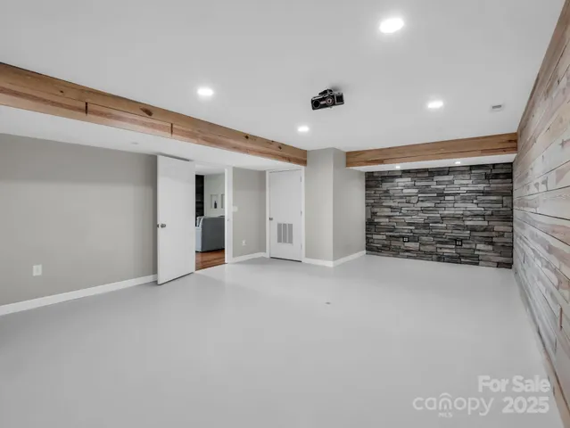 a view of an empty room with brick wall and closet