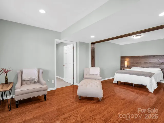 a bedroom with furniture and wooden floor