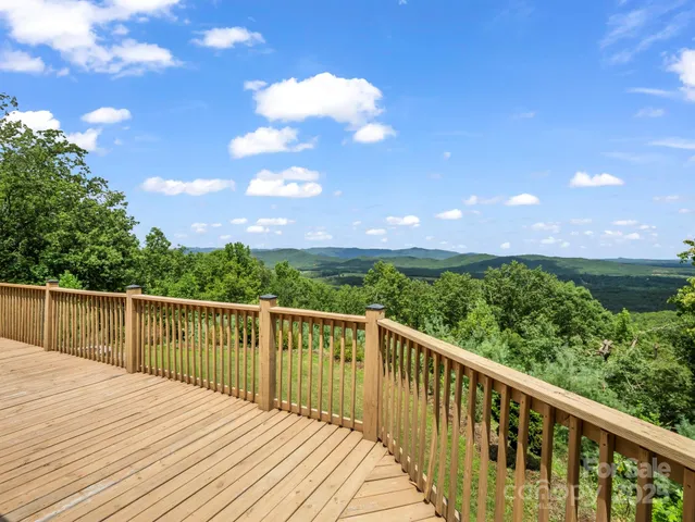 a view of balcony with wooden floor and fence
