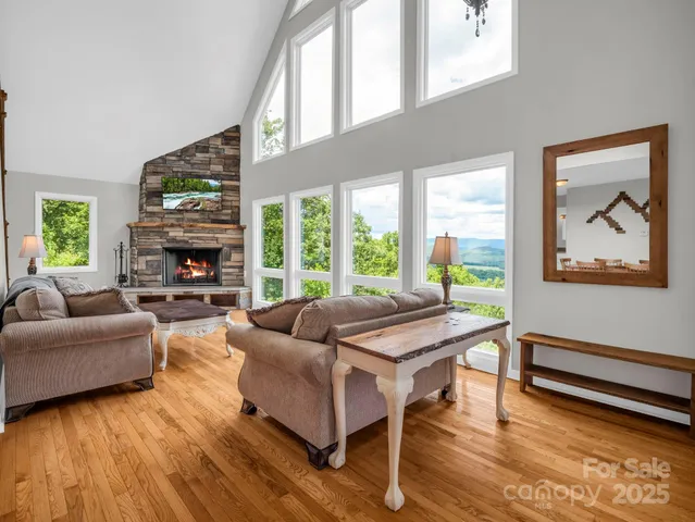 a living room with furniture a fireplace and a large window