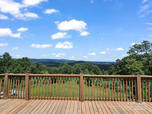 a balcony with wooden floor and city view