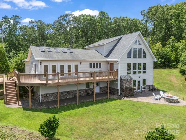 a aerial view of a house with a yard table and chairs