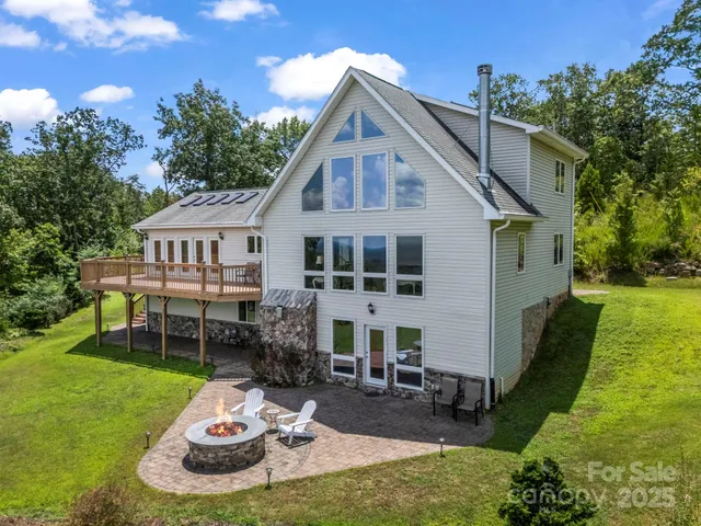 a view of a house with backyard porch and sitting area