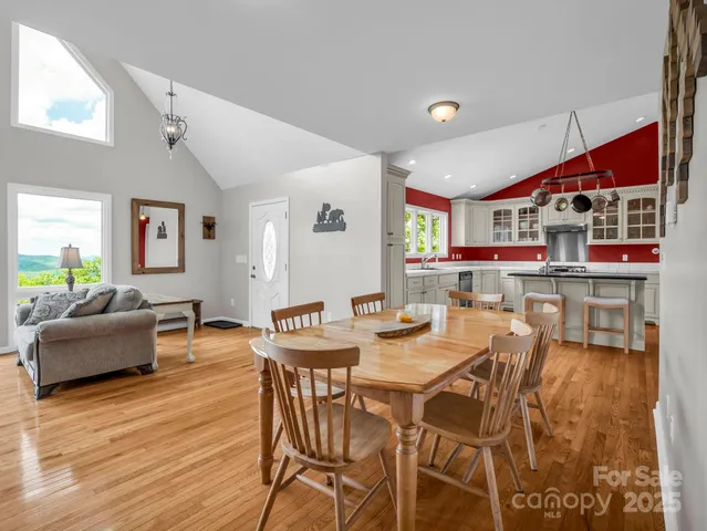 a view of a dining room with furniture and wooden floor