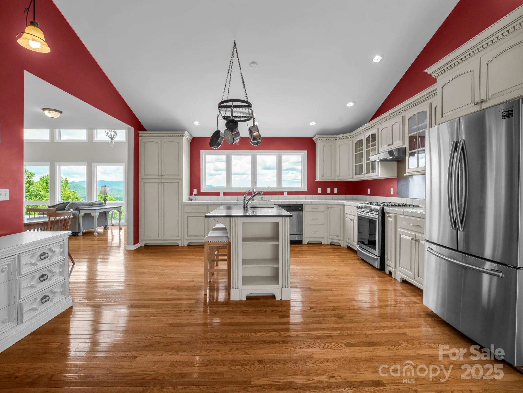 995 Towery Trace Road Ellenboro, NC 28040 - Photo 9 of 47 a kitchen with stainless steel appliances granite countertop a refrigerator a stove top oven a sink dishwasher and white cabinets with wooden floor