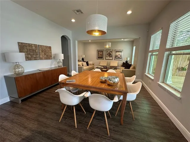 a view of a dining room with furniture window and wooden floor