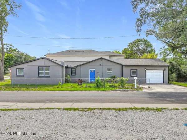 a front view of a house with a yard and a garage