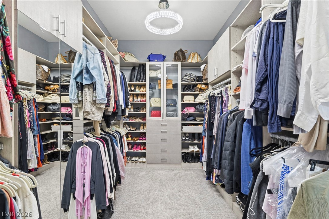 4208 Lapis Ridge Court Las Vegas, NV 89135 - Photo 29 of 61 Floor-to-ceiling built-ins and soft carpeting maximize space in this beautifully organized walk-in closet.