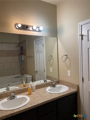 a view of a room with a window and a ceiling fan