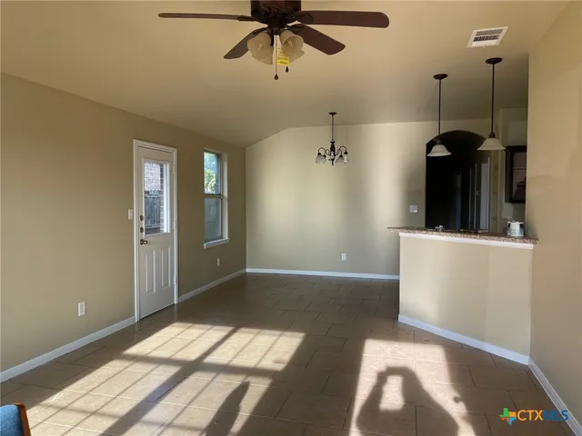 a view of a room with a window and a ceiling fan